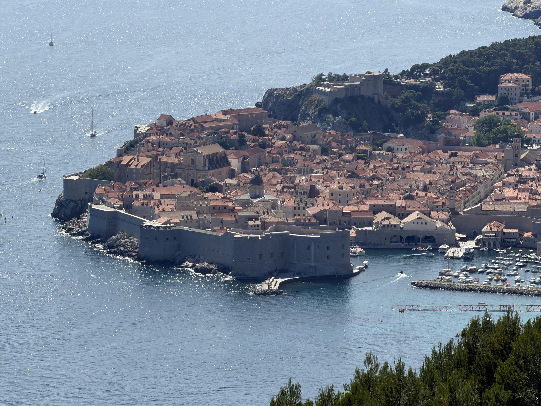 The walled old town of Dubrovnik on its peninsula, seen from the hillside above