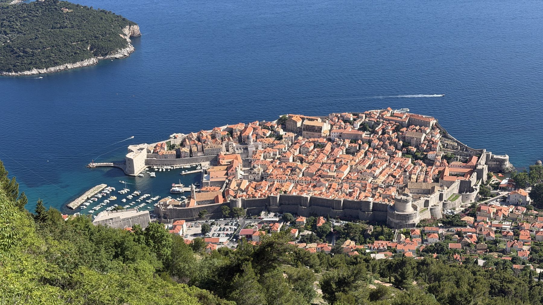 An aerial view of a walled Adriatic coastal town on a rocky peninsula