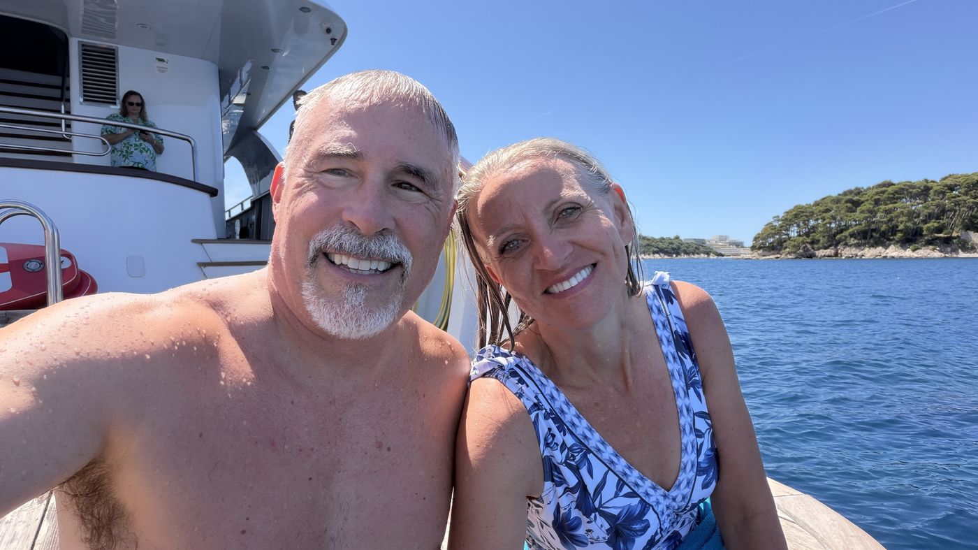 Chuck and Connie Holton aboard a boat with an Adriatic island behind them