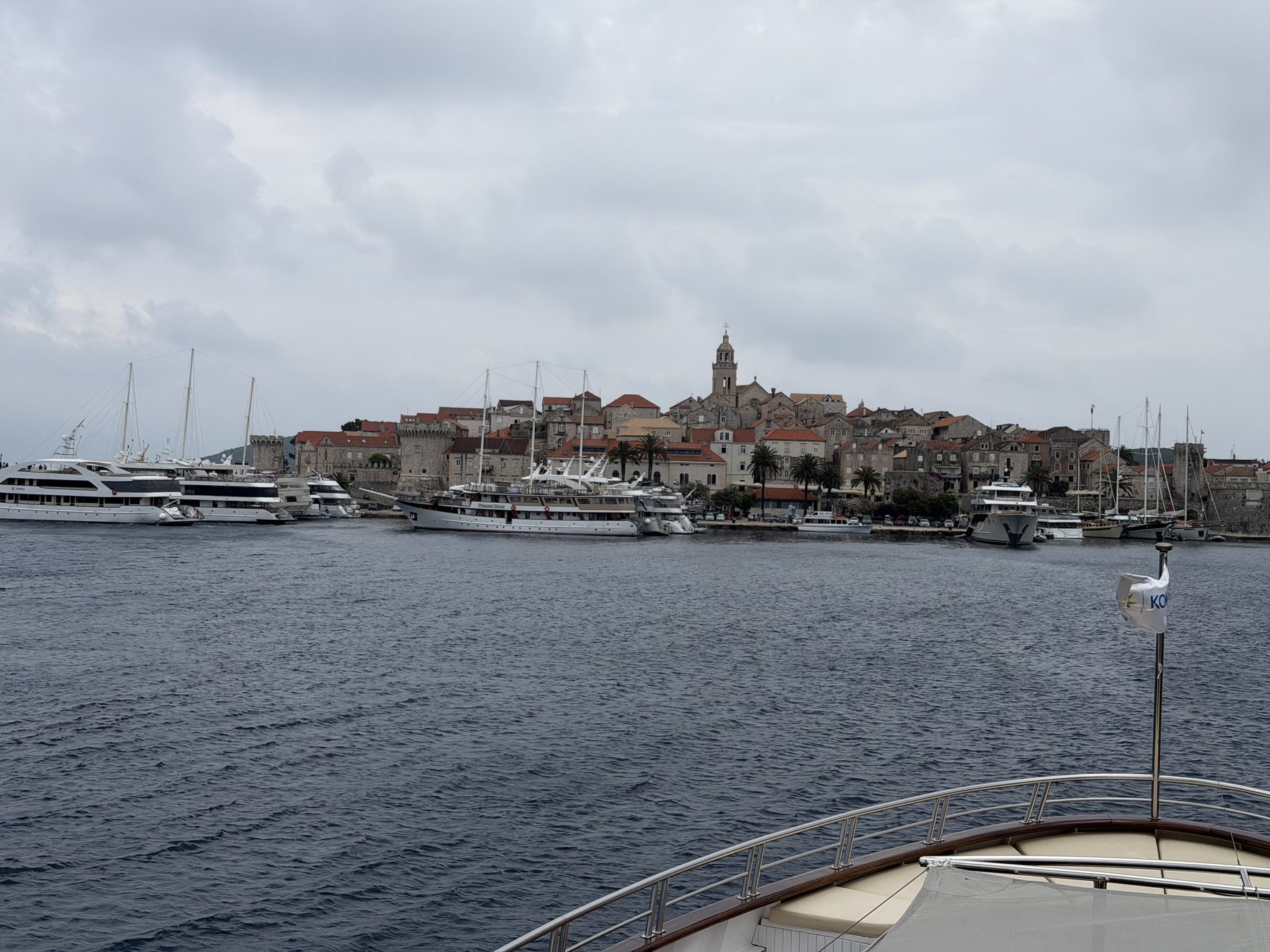 The walled town of Korcula seen from the water, its bell tower above the rooftops