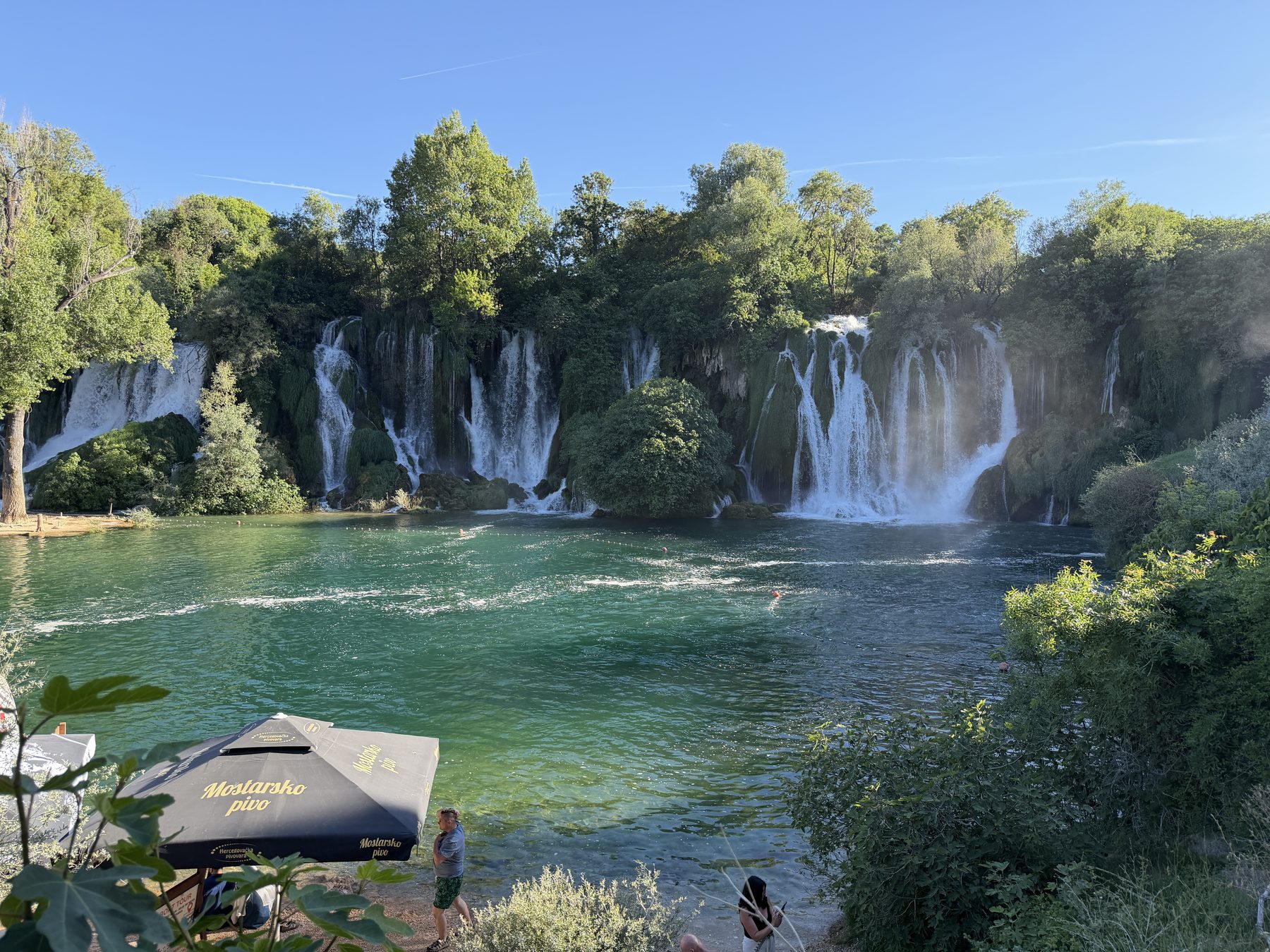 The Kravice waterfalls spilling into a green pool in Bosnia and Herzegovina