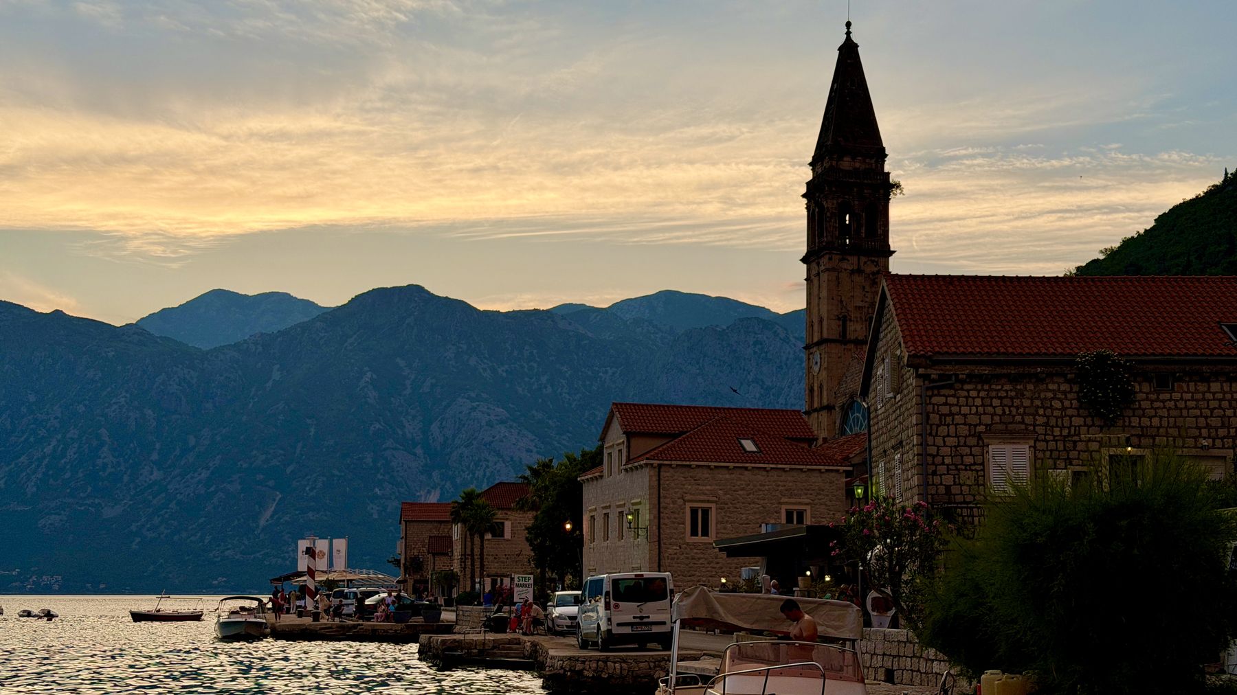 The waterfront town of Perast and its church at sunset on the Bay of Kotor, Montenegro