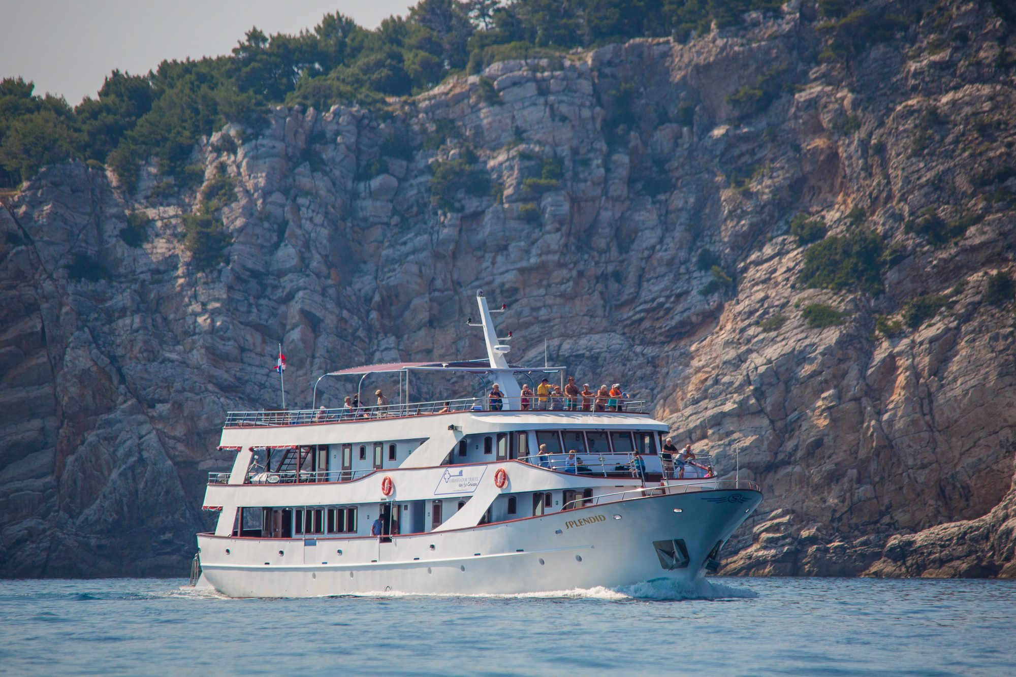 The MS Splendid running close under the cliffs of the Dalmatian coast, guests lining her top deck