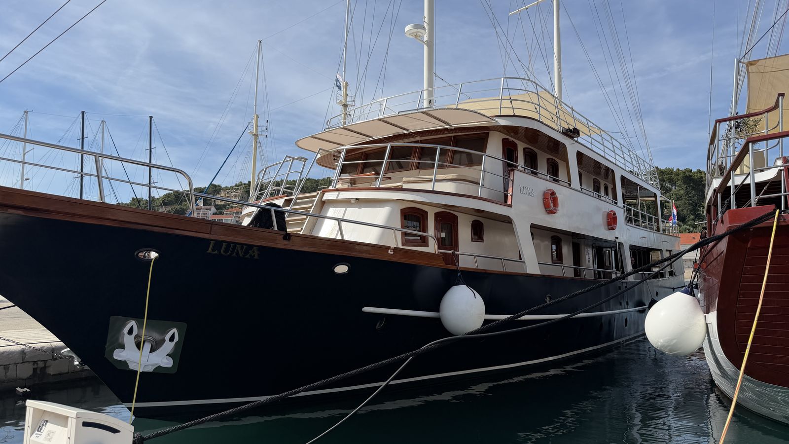 The wooden bow and deck of the private cruise yacht